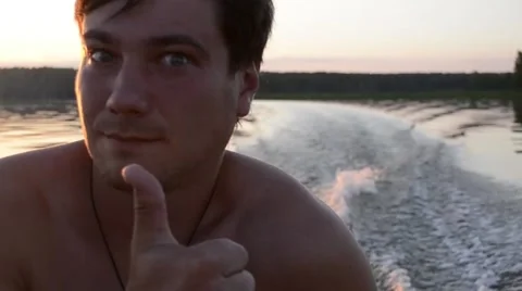 A man in a boat at sunset Stock Footage 68085834