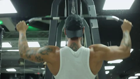 Man Bodybuilder Does Exercises For Back Tightening Stock Footage 136101557