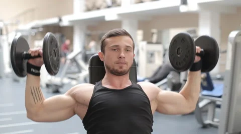 Man bodybuilder execute exercise with dumbbells in gym. Stock Footage 62562168