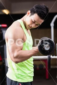 Man bodybuilder lifting weights during workout Stock Photos