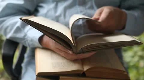 Man with books in lap Stock Footage