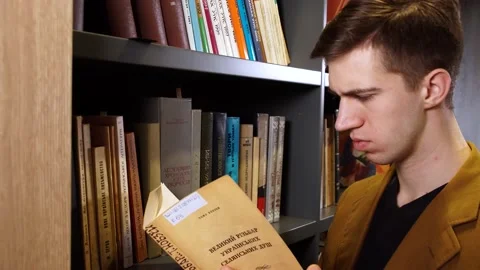Man at the bookshelf Stock Footage 155963115