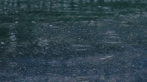 Man in Boots Step on a Puddle and Create a Splash in Slow Motion Stock Footage 81584773