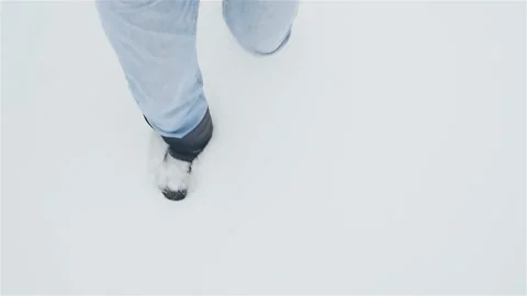 A man in boots is walking in the snow. Close-up of legs. Winter season. Stock Footage 119912406