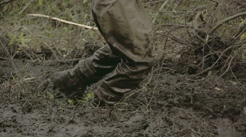 A man in boots walking onto the thick mud fs700 4k Stock Footage 42919485