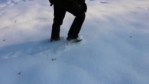 Man In Boots Walking Through Crisp Snow, slow motion. Видео 83680483