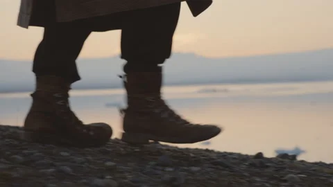 Man In Boots Walking Through Icelandic Landscape At Sunset Stock Footage 163829560