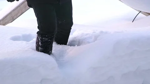 A man in boots walks through snowdrifts. Stock Footage 196894214