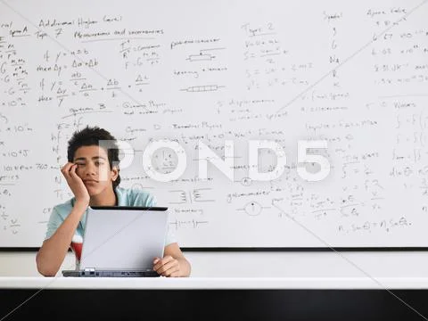 Man Bored With Laptop In Classroom Stock Photos