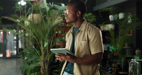 Man, botanist and thinking with tablet at shop, inventory management and contact Stock Footage 323301788