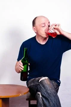 Man with a bottle of drinking red wine Stock Photos