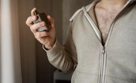 Man with a bottle of perfume Stock Photos