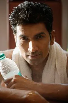 Man with bottled water, after work out Stock Photos