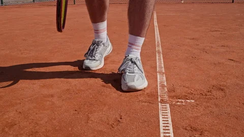 Man Bouncing Tennis Ball on Clay Court for Training Session 動画素材 345025564