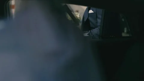 The man with bouquet going behind the car Stock Footage 219883487
