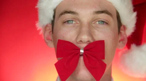 A Man with Bow tie placed on his mouth tries holding it Stock Footage 22750763