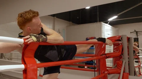 Man boxer stretching leg before boxing training on box ring in fight club Vídeo Stock 107790889