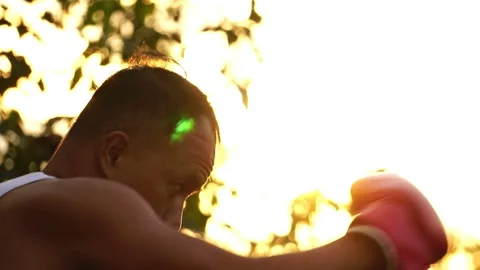Man boxer training on sunset at outdoor park Stock Footage 158996001