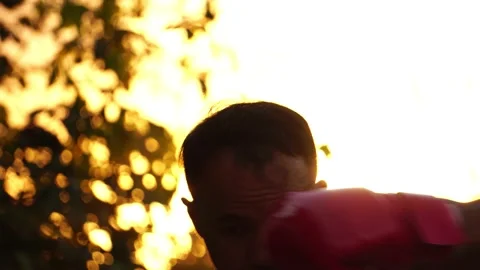 Man boxer training on sunset at outdoor park Stock Footage 158996010