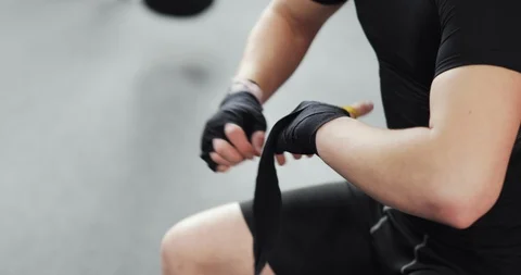 Man boxer wrapping hands tape before fighting or training in gym, closeup hands. Stock Footage 127101638