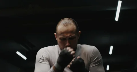 Man boxing against camera in hand wraps Stockbeeldmateriaal 125259080