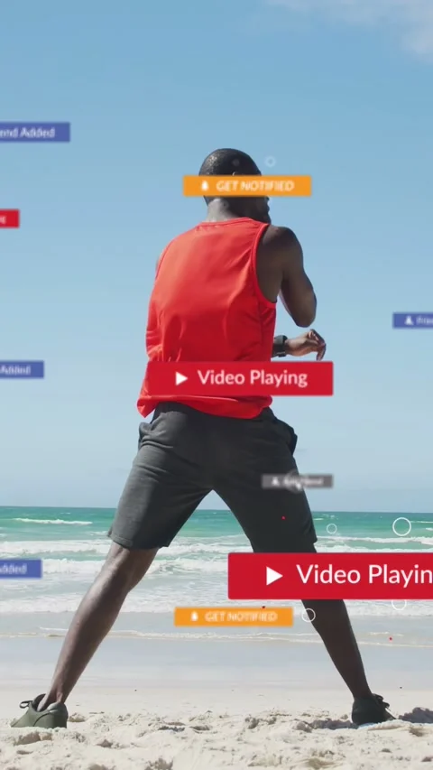 Man boxing on beach while Play button appearing and alerts floating around, Stock Footage 333079590