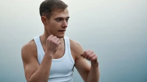 Man Boxing at the camera Stock Footage 98992563