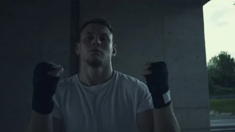 Man in Boxing Gloves Practicing Stance under a Bridge Vidéo 313958313