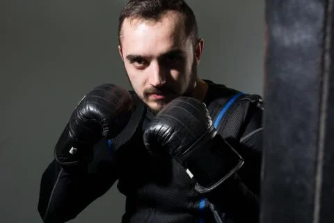 Man in boxing gloves in the rack Stock Photos