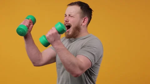 Man Boxing Playfully with Light Green Dumbbells Video stock 275852250