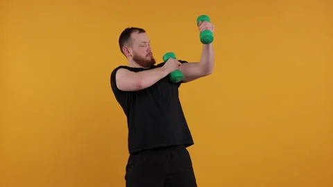 Man Boxing Playfully with Light Green Dumbbells Stock Footage 275922326