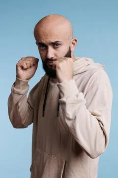 Man in boxing position looking at camera Stock Photos