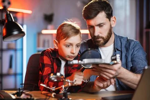 Man with boy examining problem of non working display card Stockfoto's