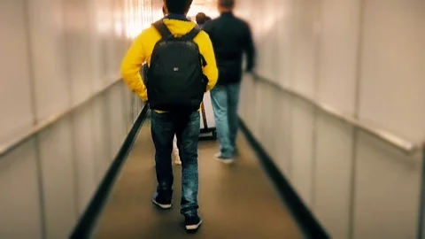 Man/ boy walking on boarding bridge to catch the flight on airport Stock Footage 103036804