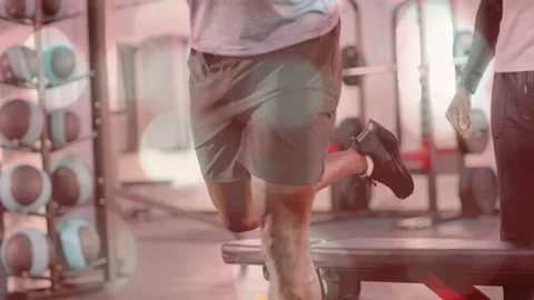Man bracing bar stepping onto bench, training split squats, coach watching, Stock Footage 333448676
