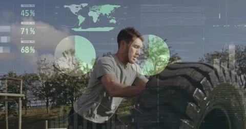 Man bracing, lifting and flipping tire for fitness as HUD analytics overlaying Video stock 331565573