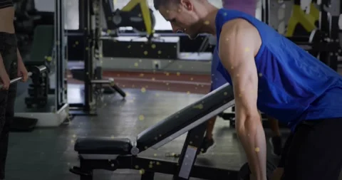 Man bracing then hinging from upright to bent-over near bench, lowering Stock Footage 328233586