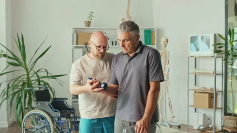 Man a Brain Stroke Doing Dumbbell Exercises as Part of a Rehabilitation Program Stock Footage 163550605