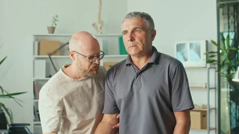 Man a Brain Stroke Doing Dumbbell Exercises as Part of a Rehabilitation Program Stock Footage 163550610