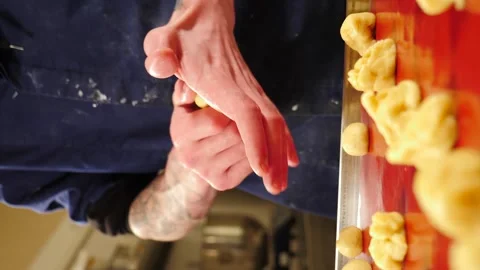 Man breadmaker employee in artisan bakery workshop preparing dough in circle Stock Footage 274338941