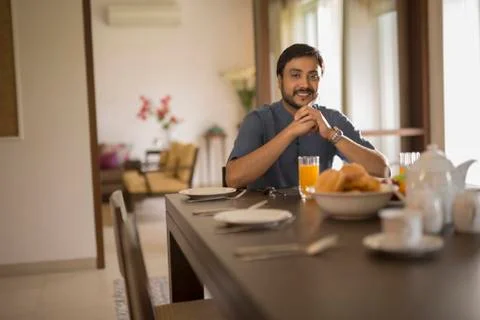 Man at breakfast table inside Stock Photos