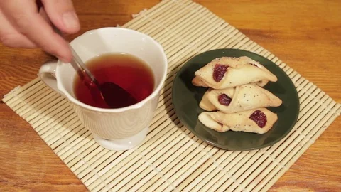 Man breakfast with tea and cookies on the wooden desk Stock Footage 71600430