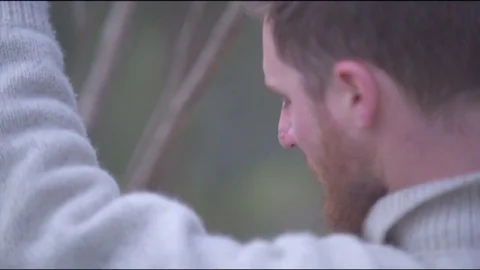 Man breaking branch of tree in forest Vídeos de archivo 76101855