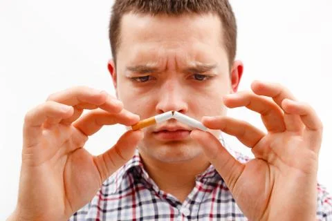 Man breaking cigarette in two Stock Photos