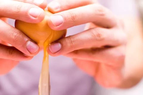 A man is breaking an egg. Cooking, baking. Stock-Fotos