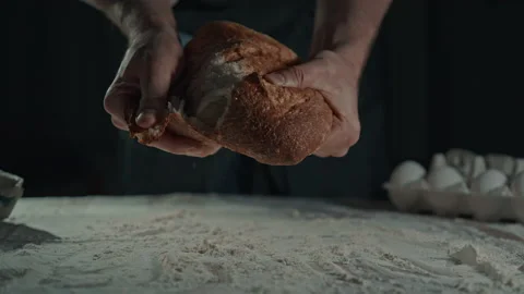 Man breaking freshly bread Stock Footage 237525526