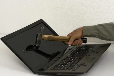 Man breaking pc with hammer Stock Photos