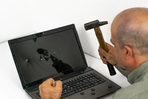 Man breaking pc with hammer Stock Photos