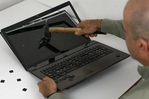 Man breaking pc with hammer Stock Photos