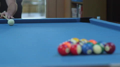 Man Breaking Racked Pool Balls on Blue Billiards Table Stock-Footage 65971368